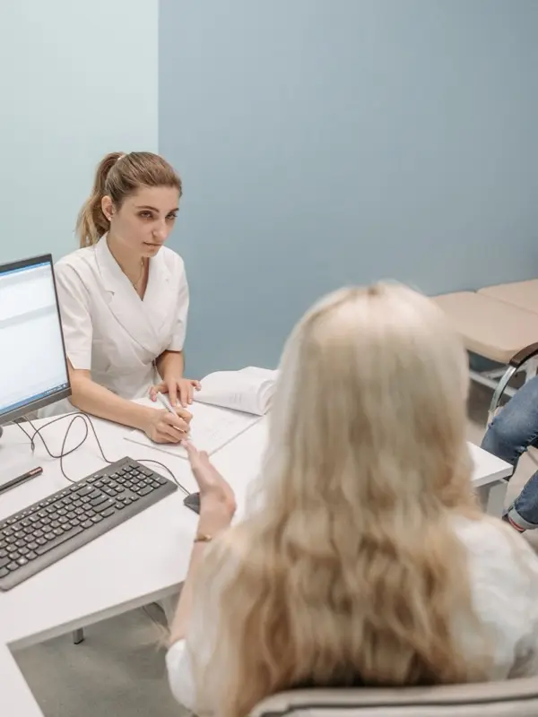 A doctor consulting a patient in a clinic office