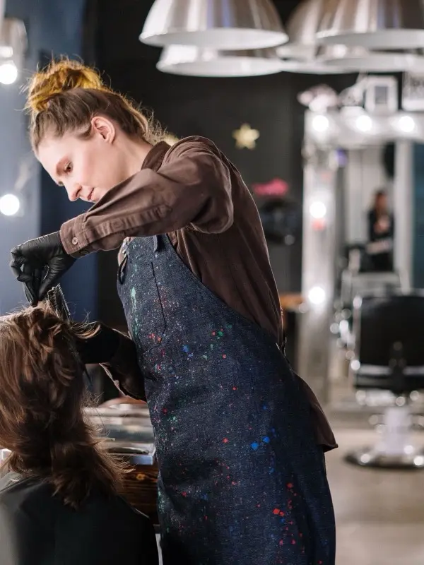 A master at work with a client in a studio with several stations